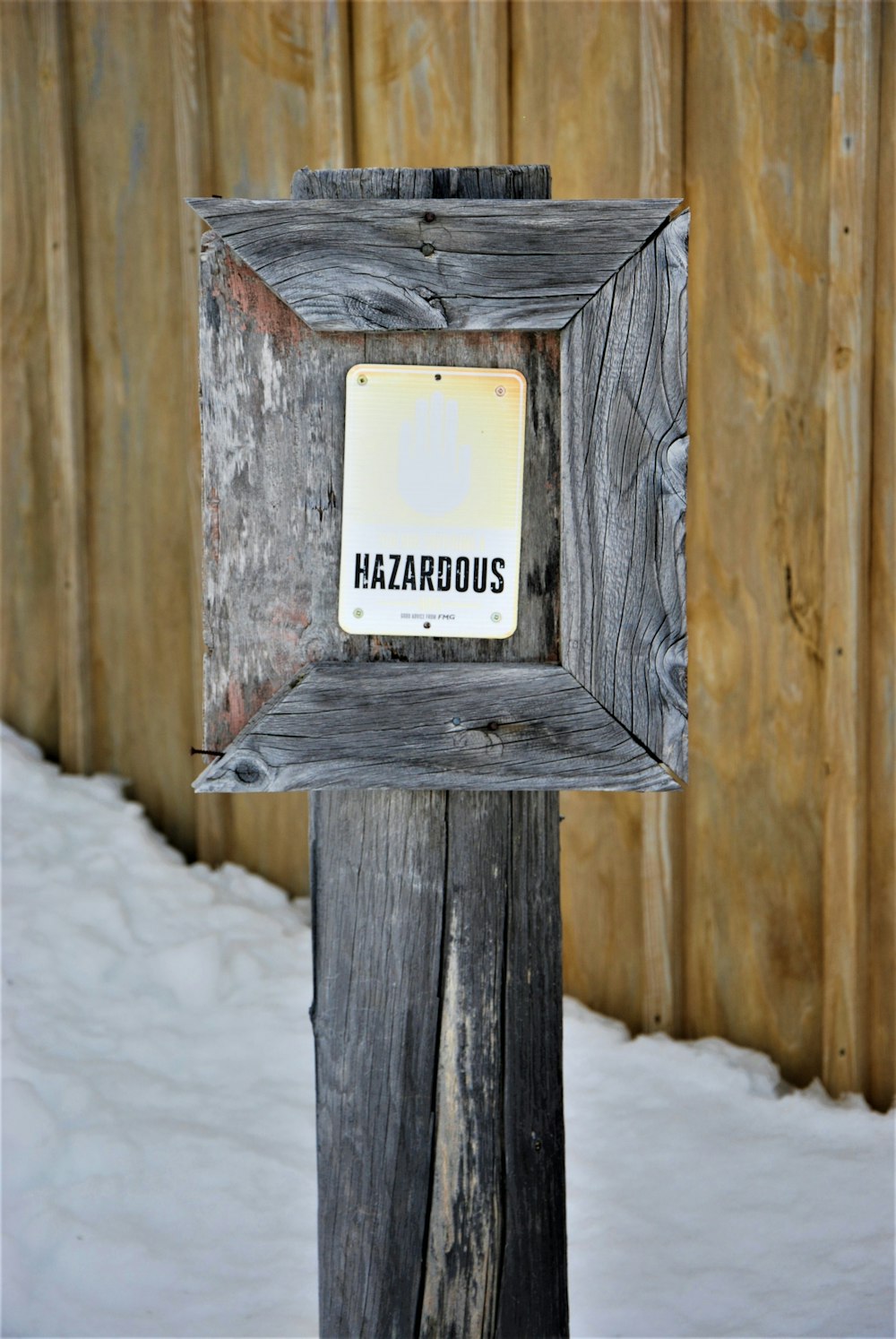 a wooden post with a sign on it