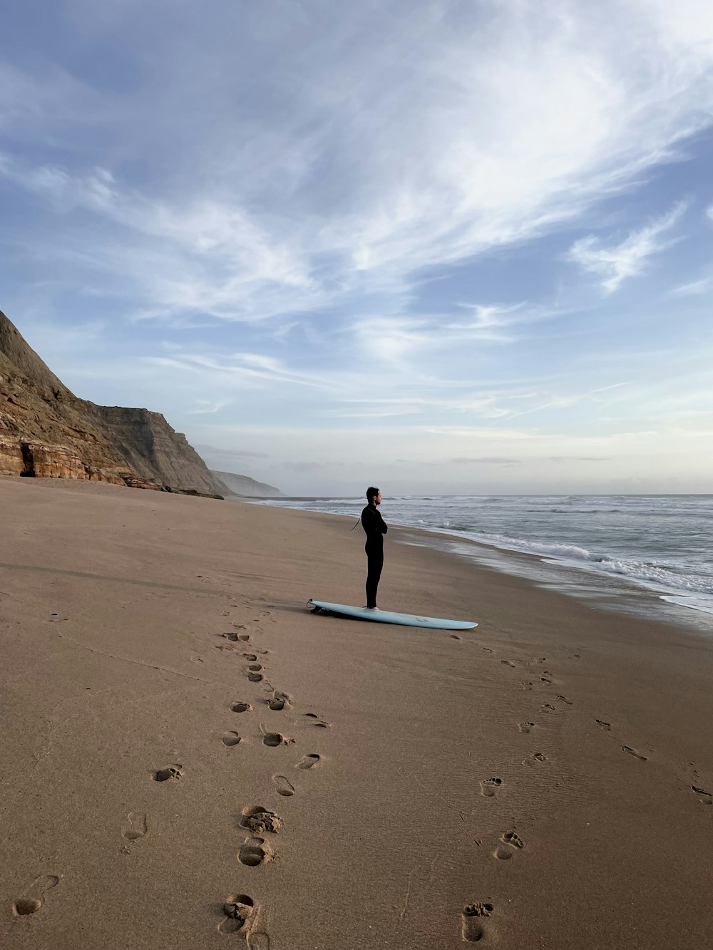 a person on a surfboard on a beach