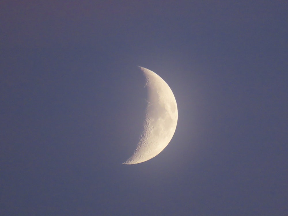 a half moon in a blue sky