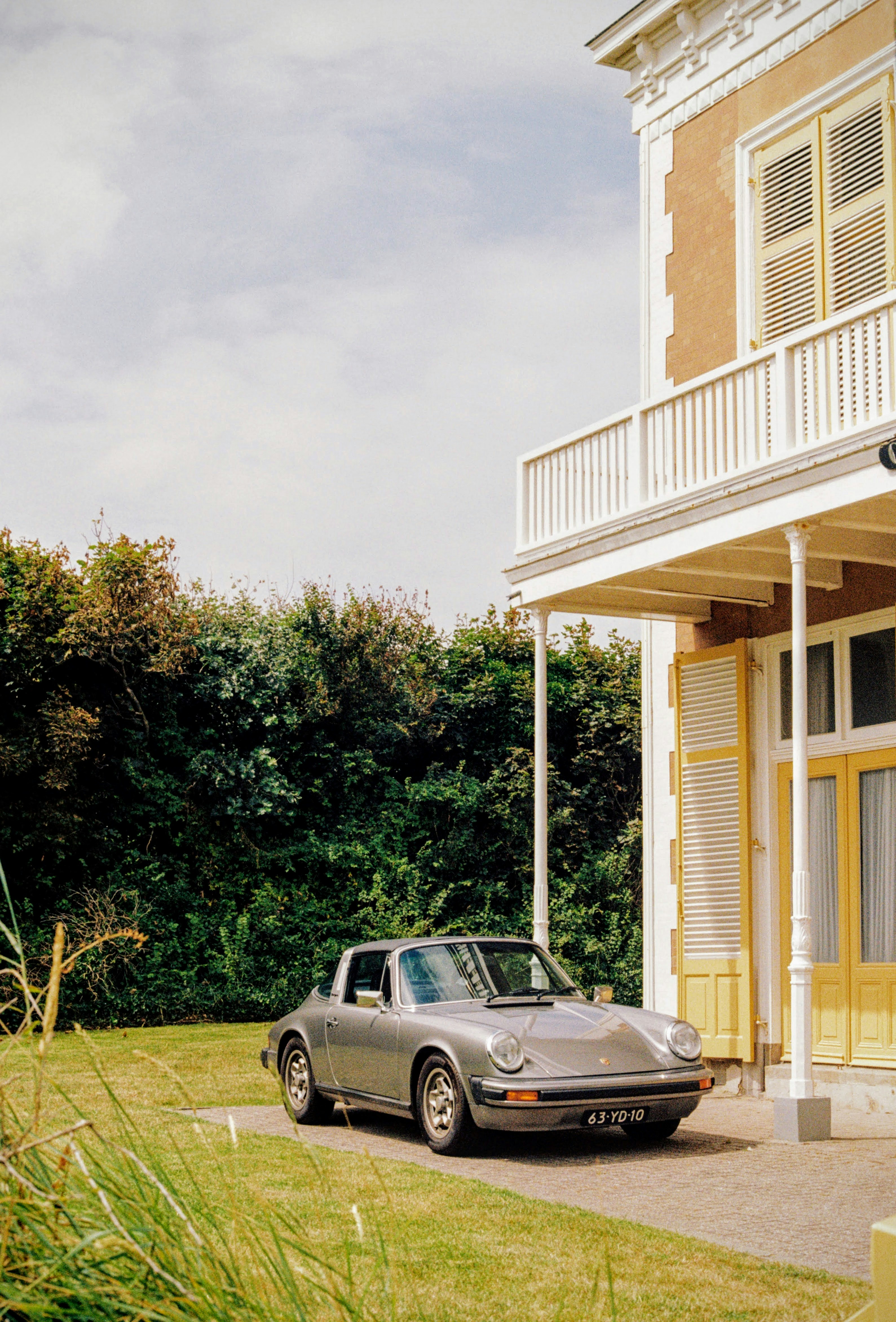 A car parked in front of a house photo – Free Porsche Image on Unsplash