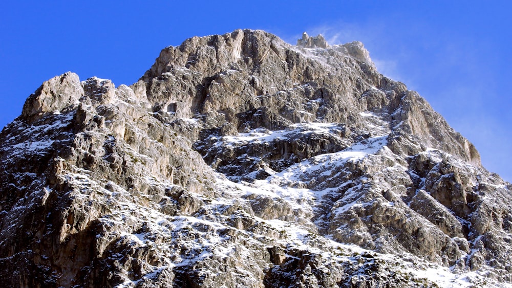 a rocky mountain with snow