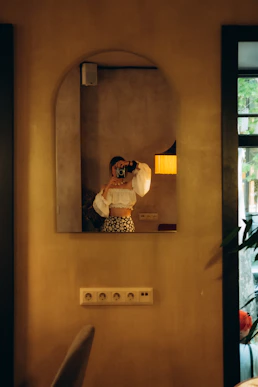 a person taking a picture of herself in a mirror