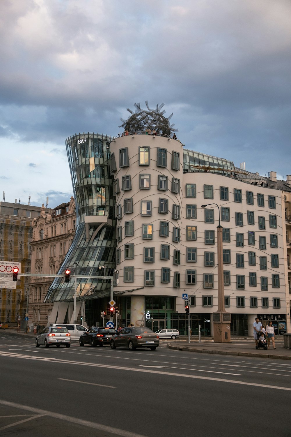 a large building with many windows with Dancing House in the background