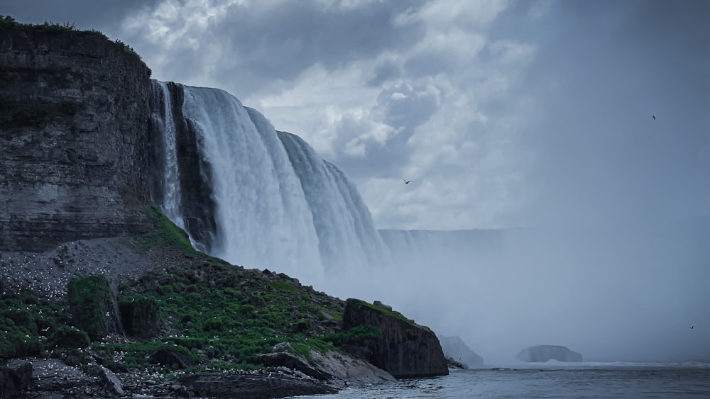 a cliff side with a waterfall