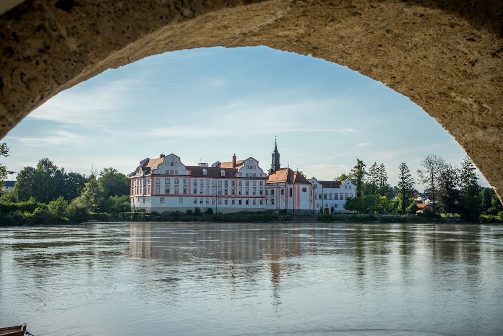 a building with a large archway over a body of water