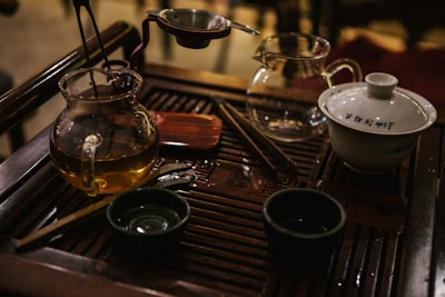 A serene setup of traditional Chinese tea utensils arranged on a wooden tray.