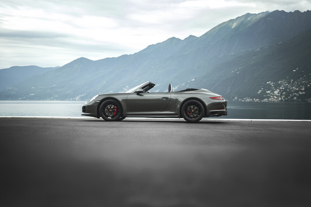 a silver sports car on a road