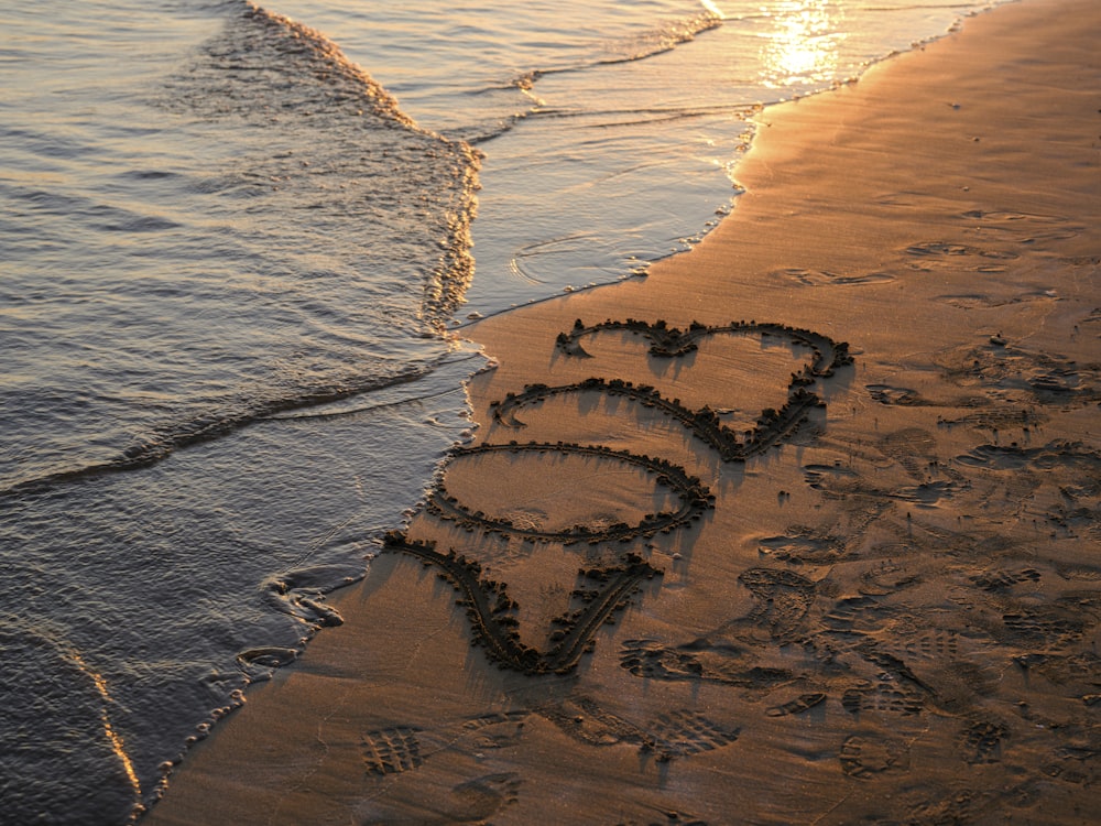 uma praia com um coração desenhado na areia