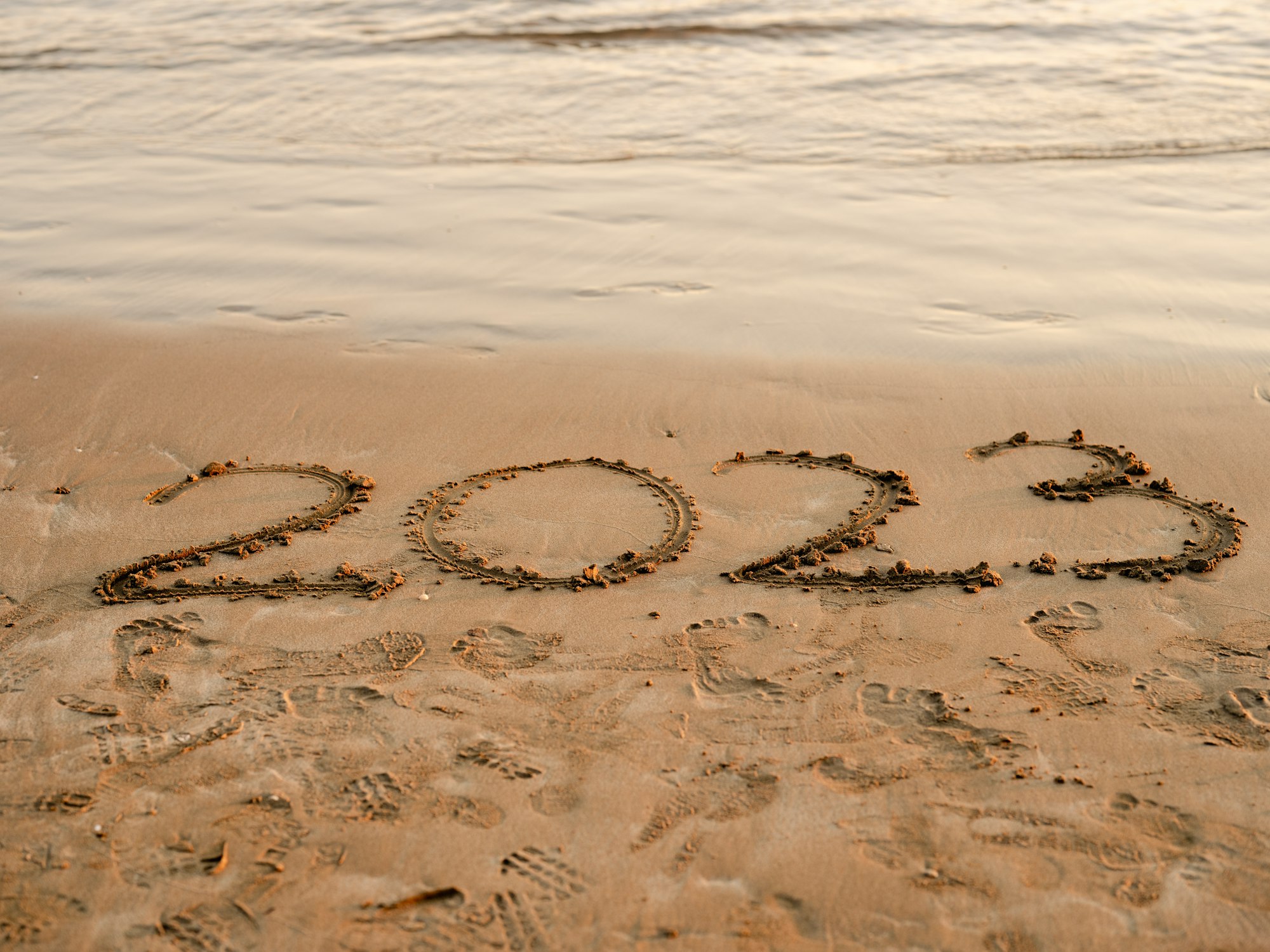 a beach with writing in the sand