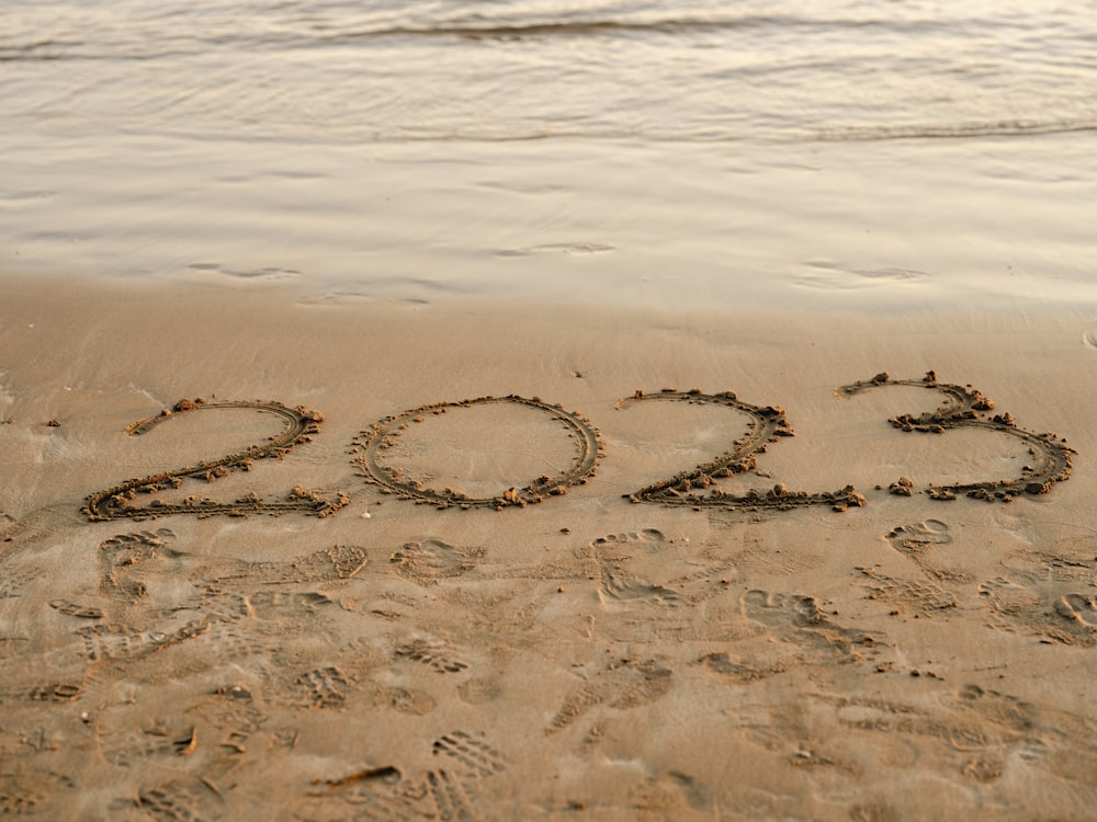 a beach with writing in the sand