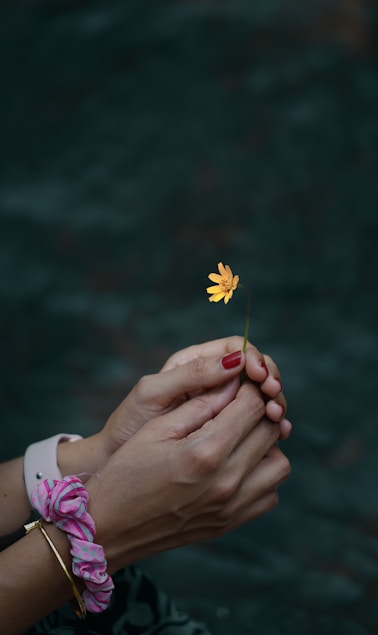 a person holding a flower