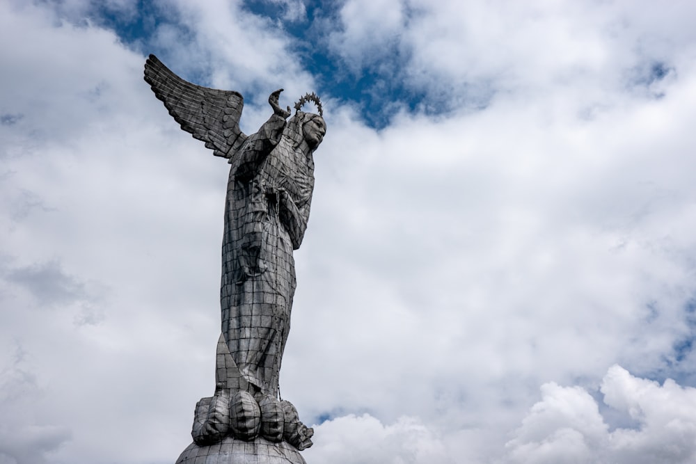 a statue of a person with a cross on the head