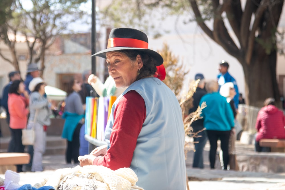 a person in a hat and coat holding a flag