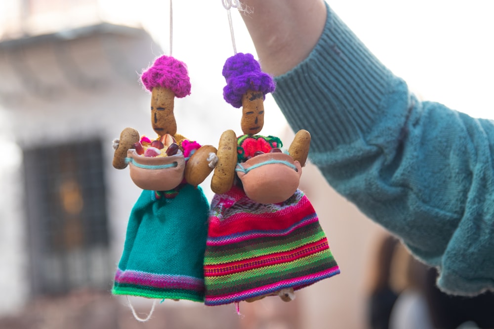 a person holding a couple of colorful ice cream cones