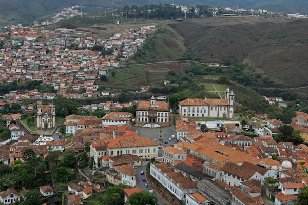 The town’s red roofs across the valley from the air — Ouro Preto, Brazil