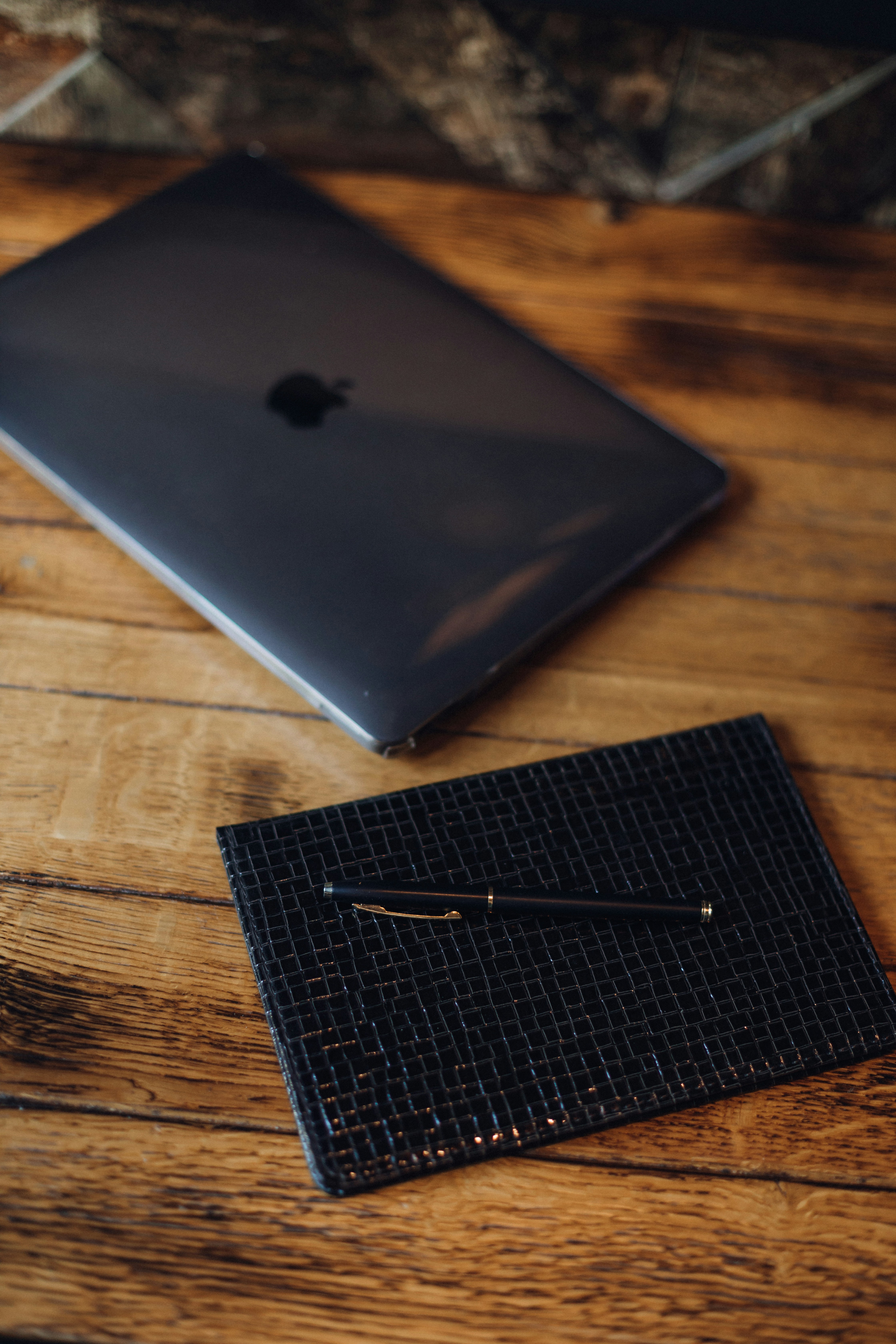 a black rectangular object on a wooden surface