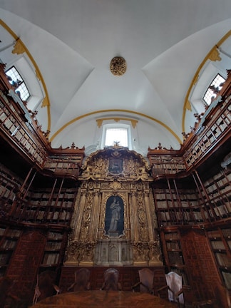 A serene seminary library corner with burgundy leather chairs and shelves filled with sacred texts.
