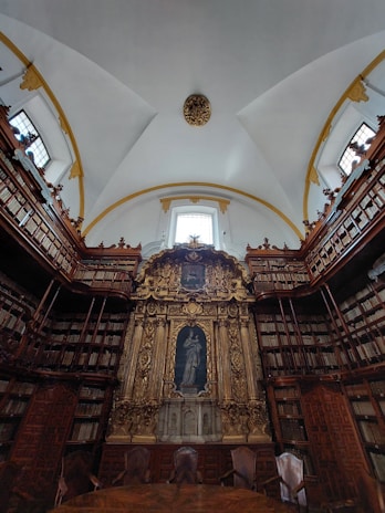 A warmly lit seminary library with rows of ancient theological books and a wooden pulpit bathed in soft light.