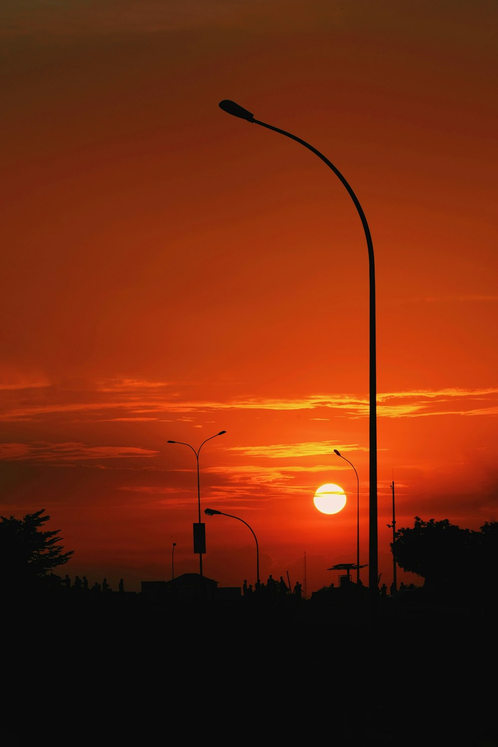 a sunset with a street light