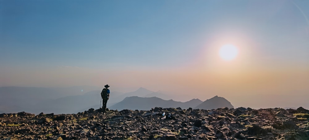 a person standing on a rocky hill