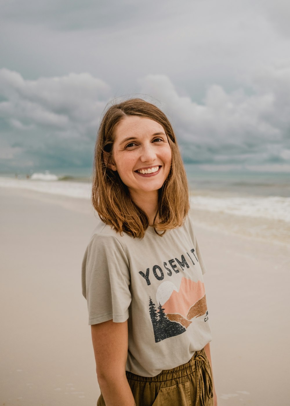 a person standing on a beach posing for the camera