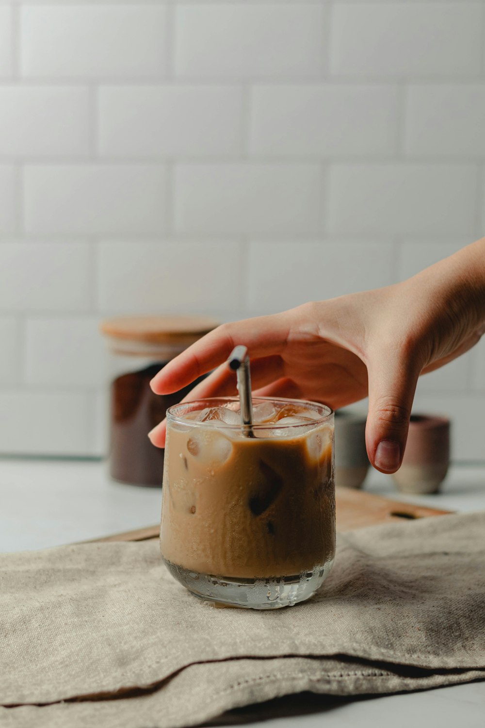 a person pouring a drink into a glass