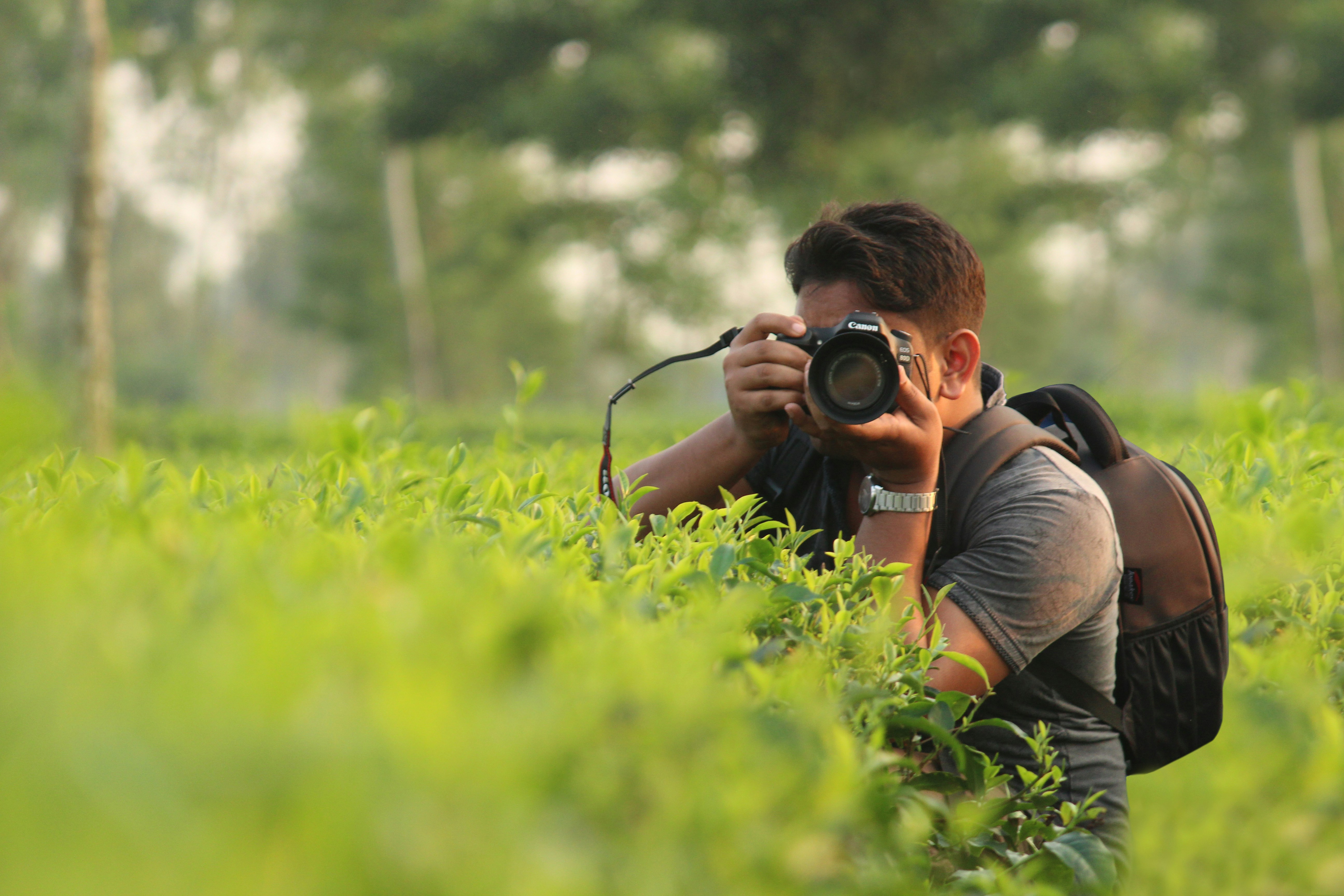 a man with a camera in a field