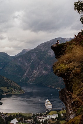 a large body of water with a mountain in the background
