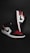 A pair of stylish athletic shoes in black, white, and red colors with distinctive branding. The shoes are positioned against a dark background, showcasing their sleek design and detailed craftsmanship.