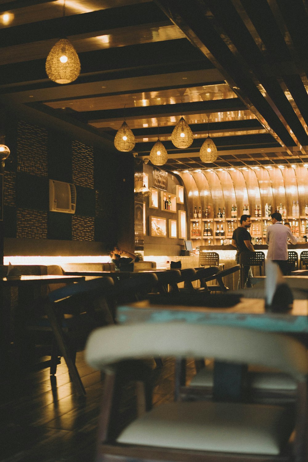 a bar with a pool table and chairs