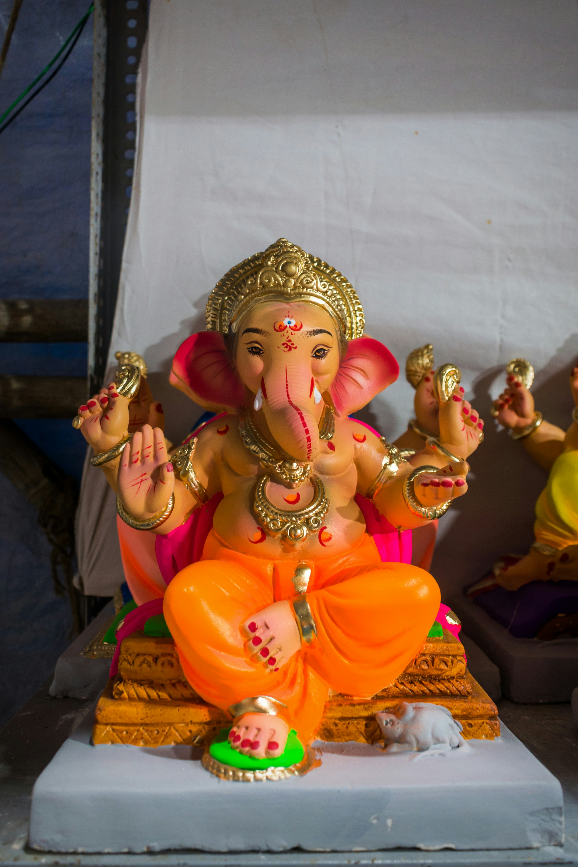 A statue of a person wearing a crown and holding a cup photo ...