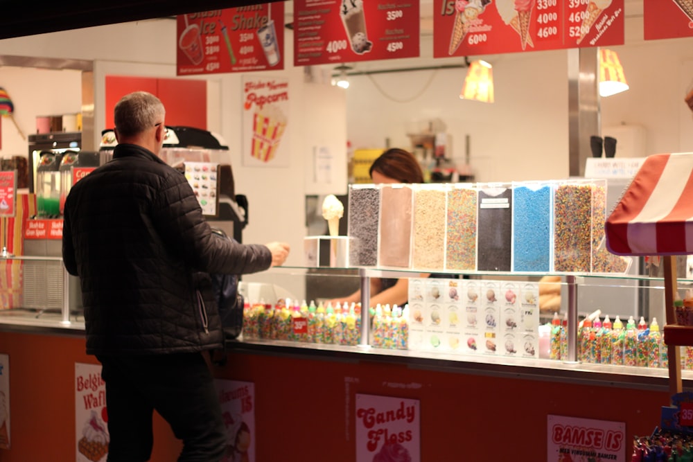 a person standing in front of a counter with products on it