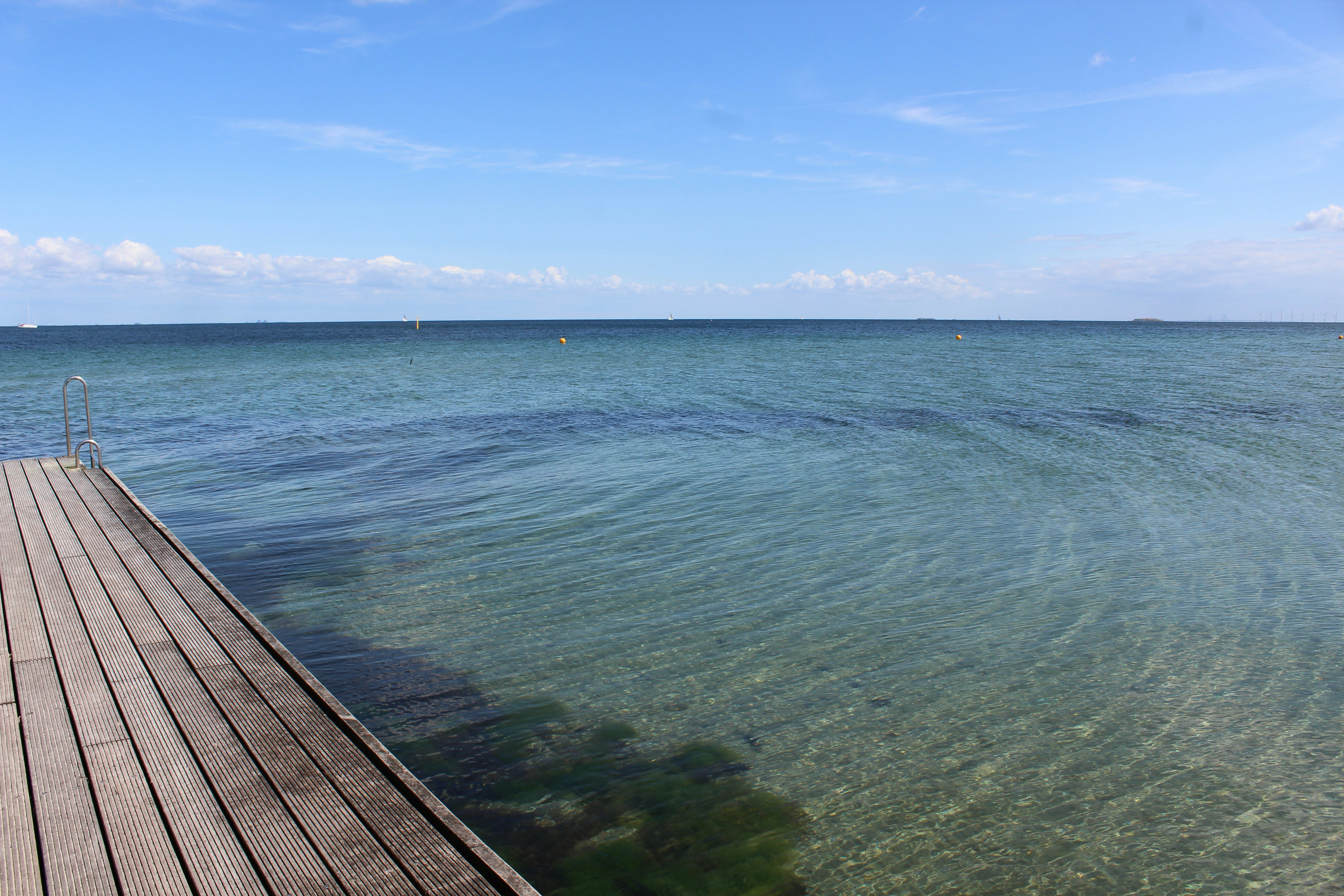 a wood dock over a body of water, 