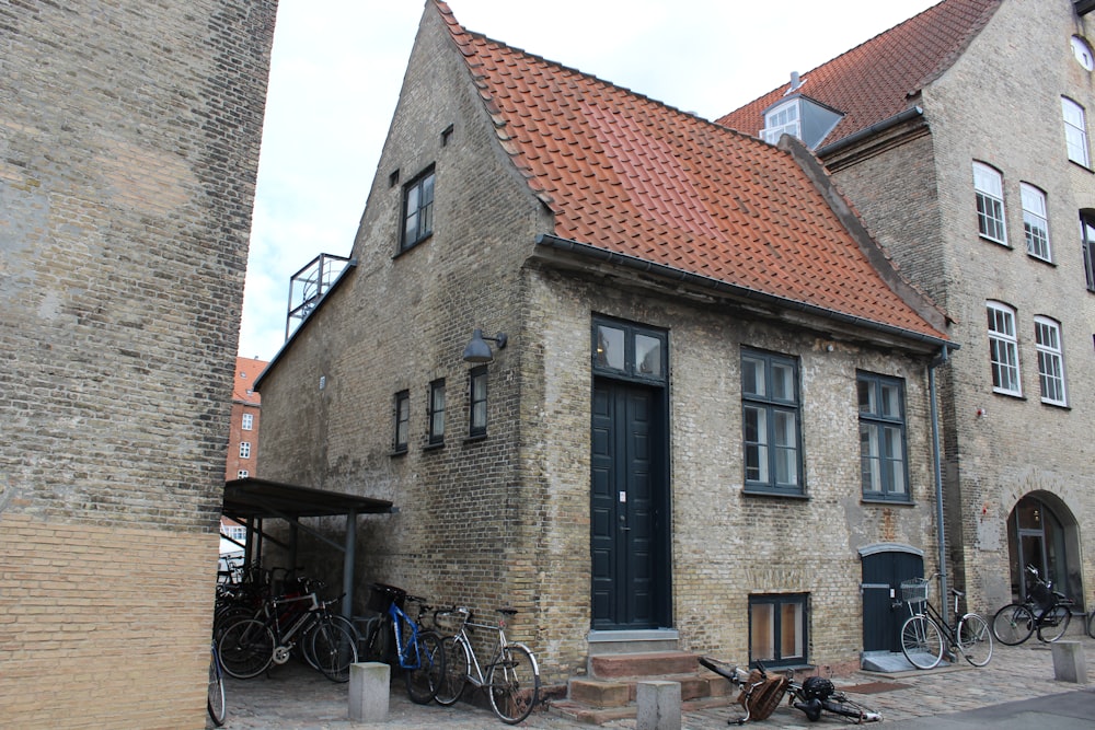 a brick building with bicycles parked outside