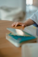 a hand holding a tablet