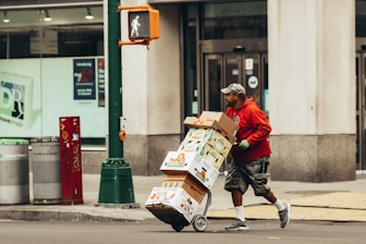 a man pushing a cart full of boxes