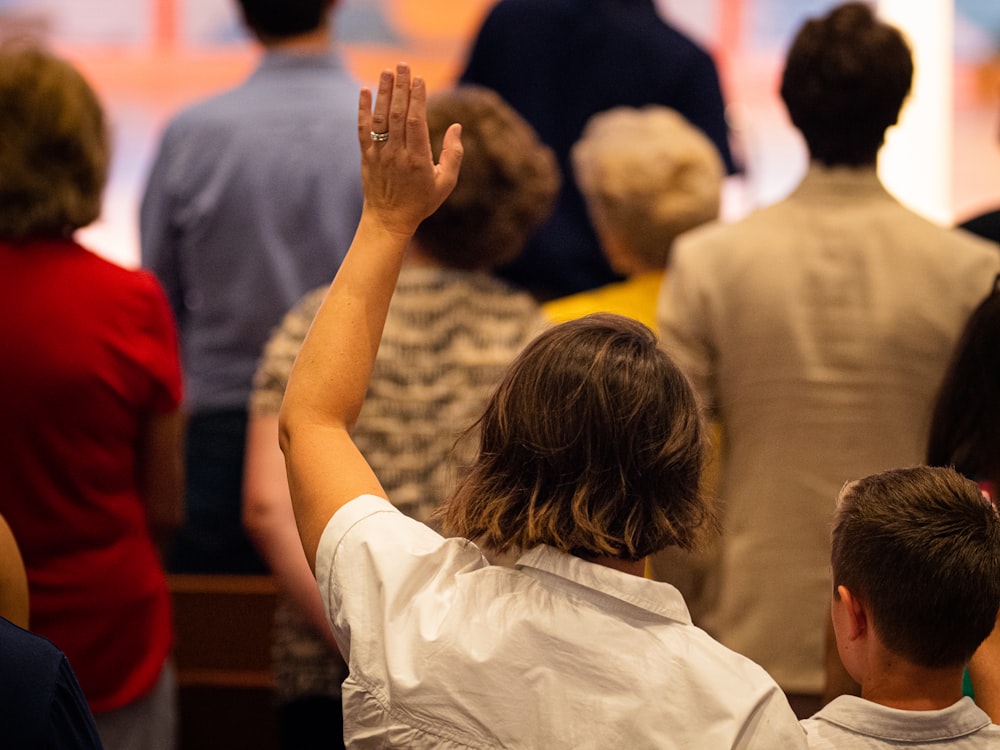 a group of people raising their hands