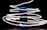 A cylindrical blue speaker stands in the center, surrounded by swirling trails of bright white light against a dark background. The light streaks create a dynamic and futuristic effect, as if wrapping around the speaker.