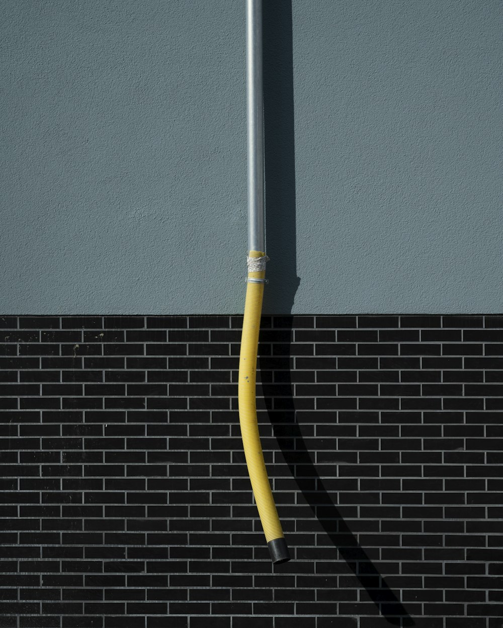 a yellow cable on a grey surface