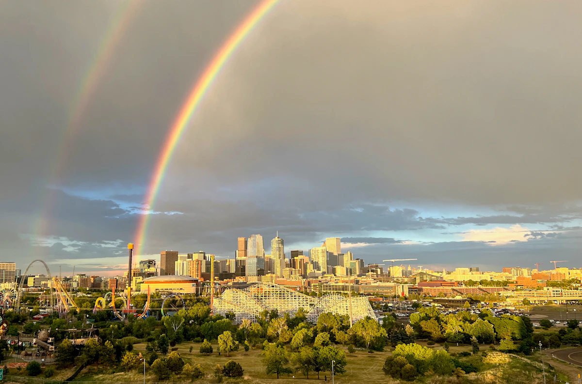 Rainbow over Denver skyline during Pride season