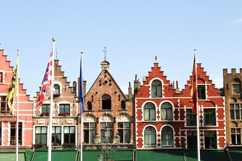 a row of buildings with flags