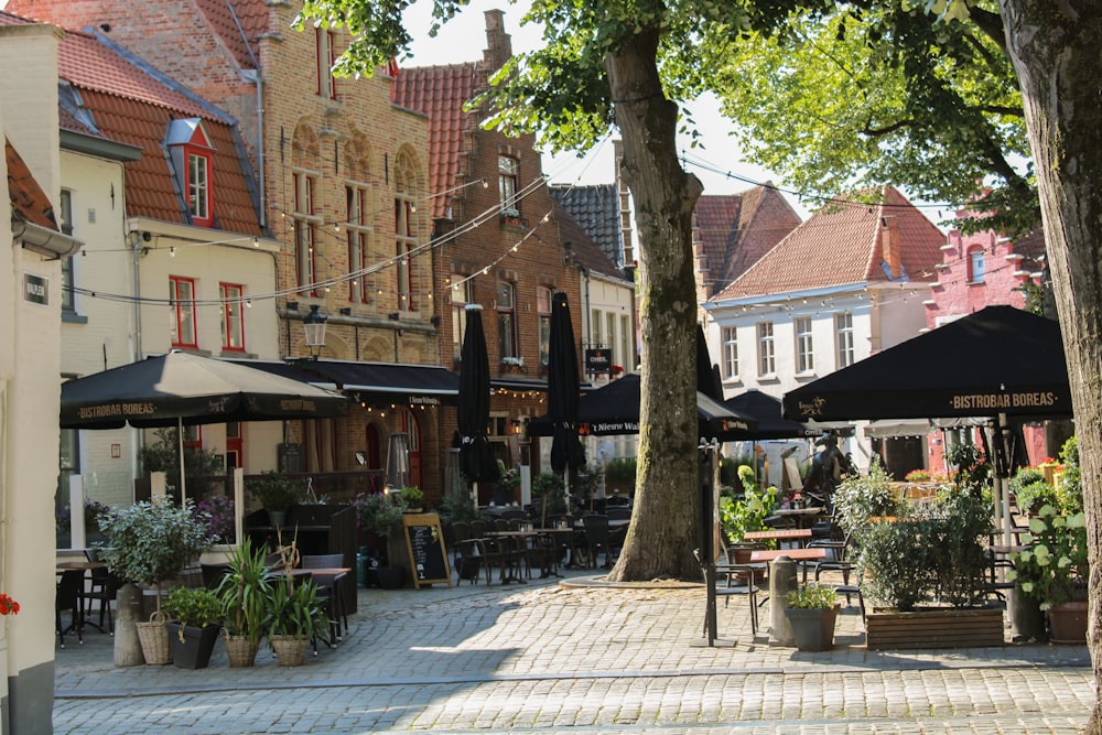 a courtyard with tables and chairs and umbrellas