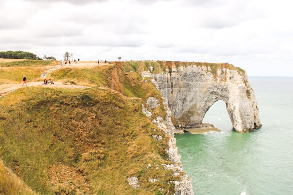 a cliff with a body of water below