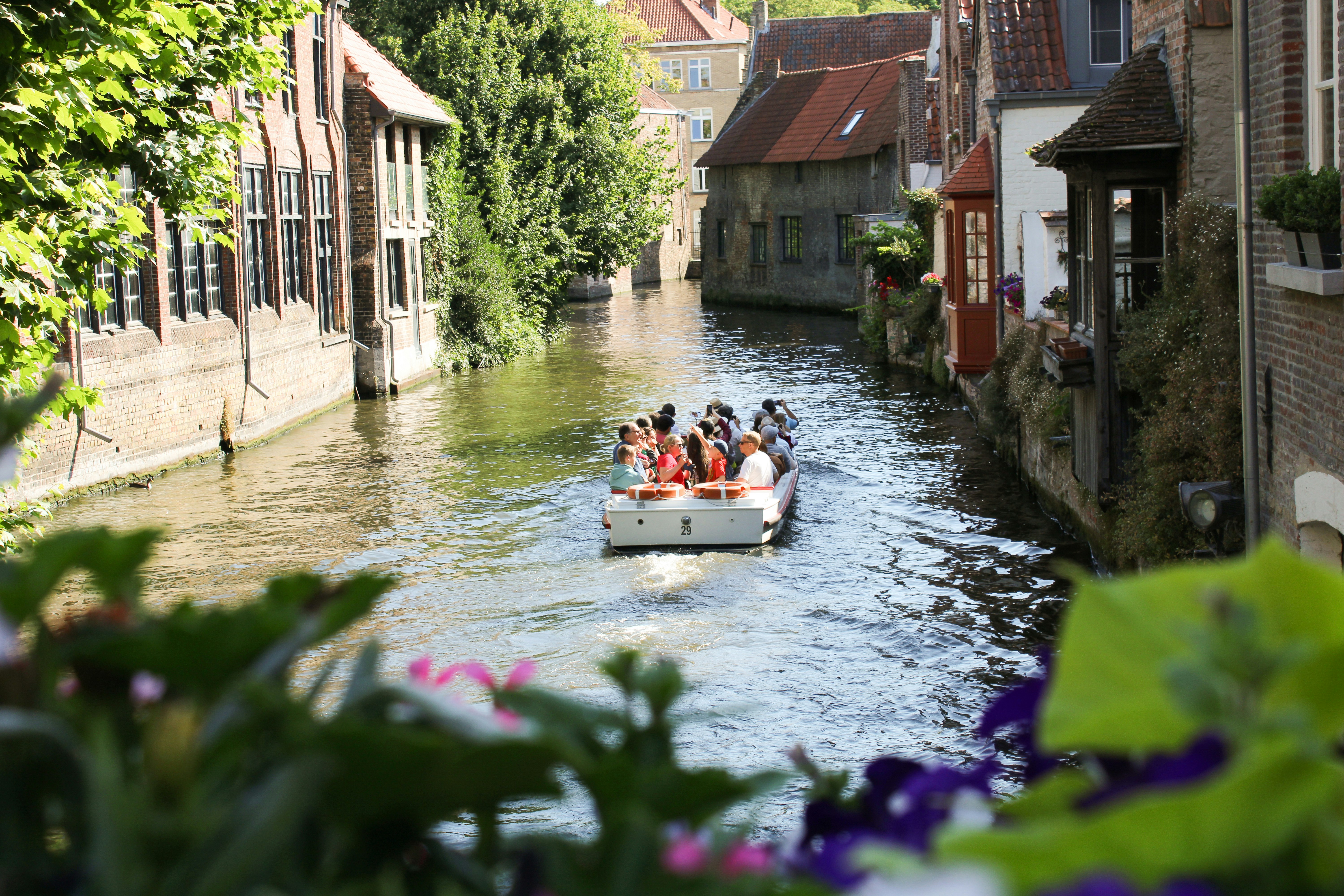 a group of people on a boat in a canal
