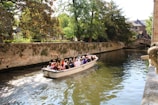 A family enjoying a boat ride through the peaceful canals of Singapore.