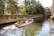 A vibrant college group enjoying a boat ride through Kerala’s backwaters at sunset.