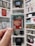 A person is holding a Game Boy cartridge with a red label featuring 'The Legend of Zelda: Oracle of Seasons' text. In the background, there are several shelves filled with video game cases, consoles, and figurines, creating a gaming-themed environment.