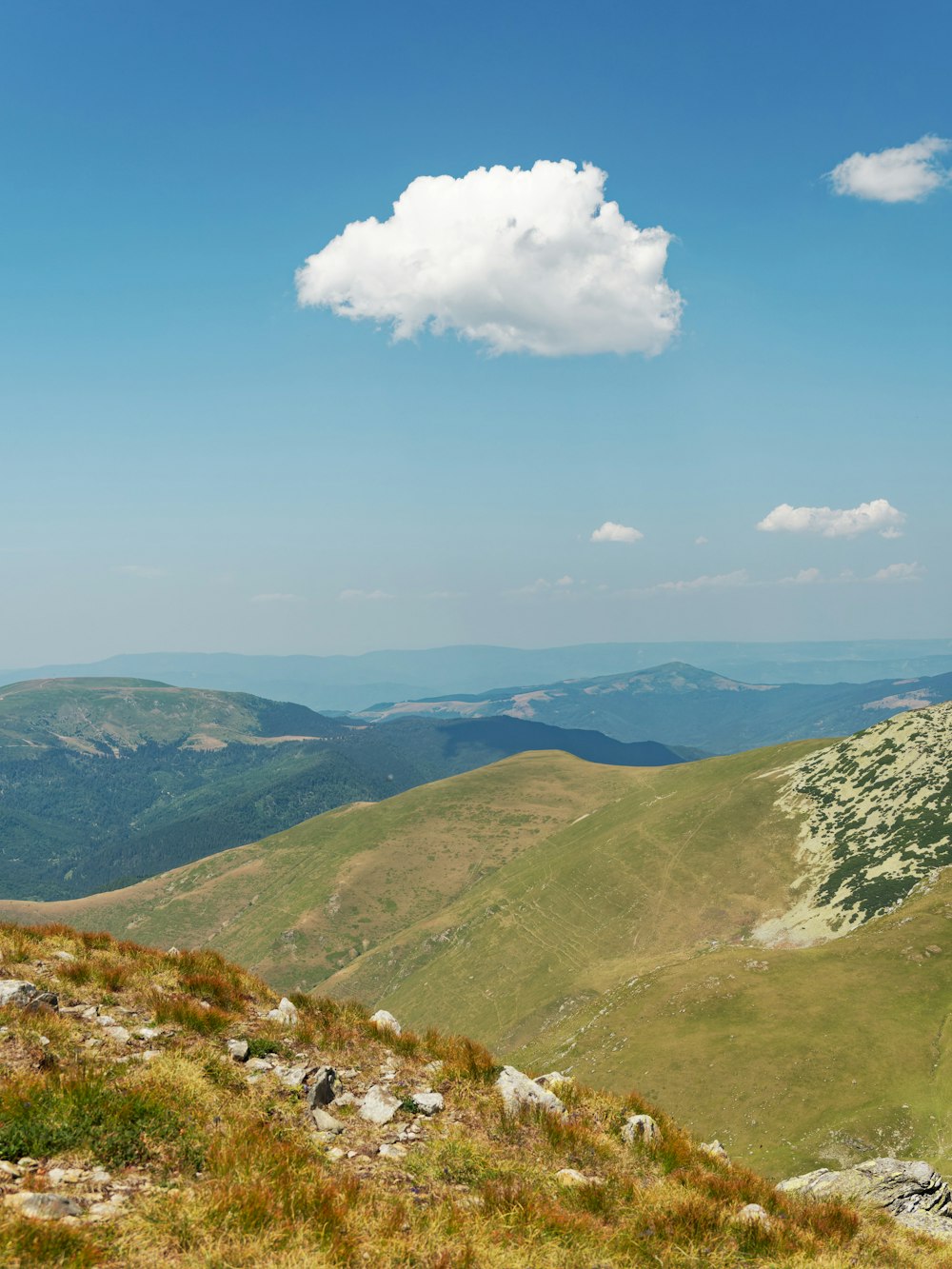 a landscape with hills and a blue sky