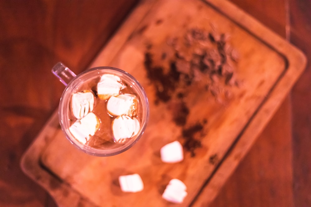 a glass of liquid with cigarettes