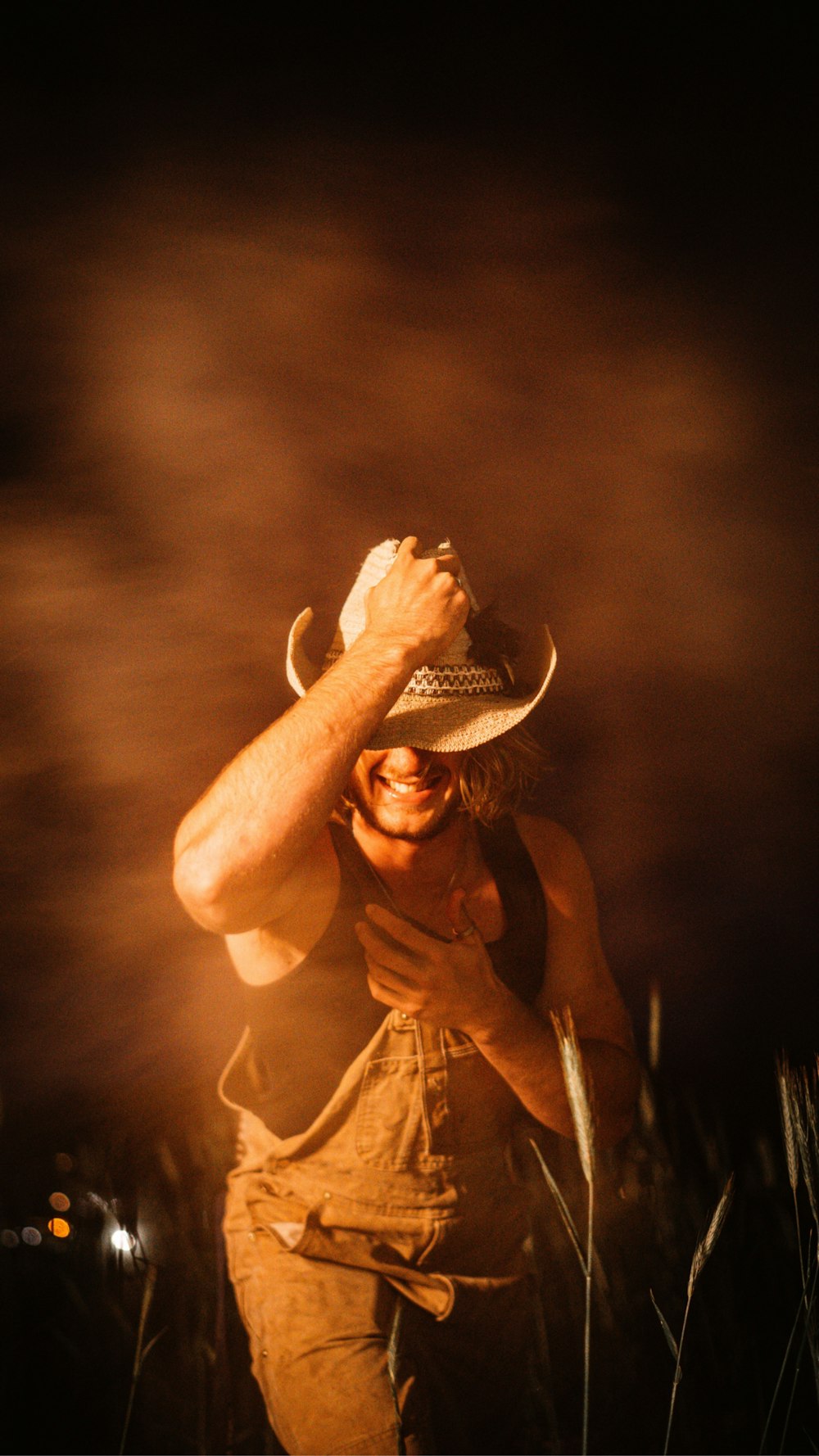 a person wearing a hat and holding a microphone